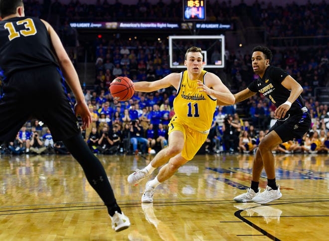 SDSU's Noah Freidel drives past Purdue Fort Wayne's Matt Holba and Jarred Godfrey during the Summit League tournament quarterfinals on Saturday night, March 7, at the Denny Sanford Premier Center in Sioux Falls.