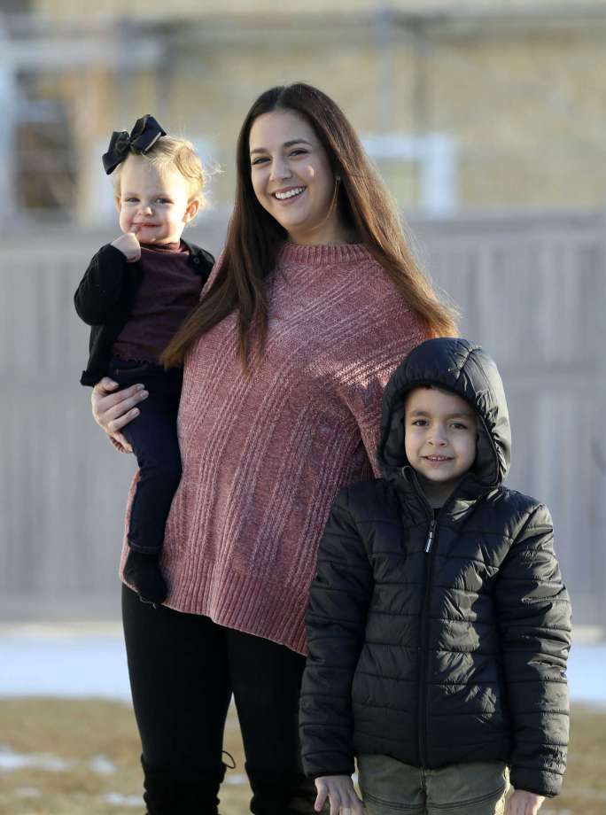 Evi Figgat, center, poses with daughter Elinor and son Oliver at their Eagle Mountain, Utah, home on Wednesday, Feb. 17, 2021. (Laura Seitz/The Deseret News via AP) Photo: Laura Seitz, AP / The Deseret News