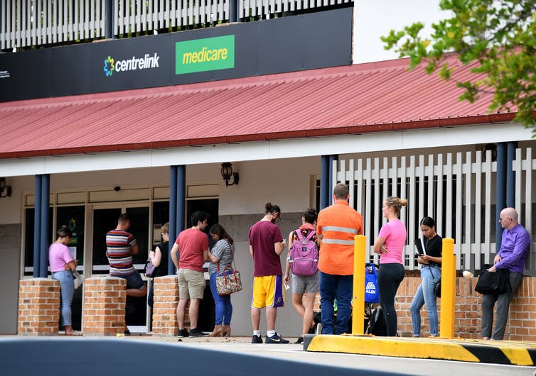 People queue outside a Centrelink office in Brisbane in 2020.