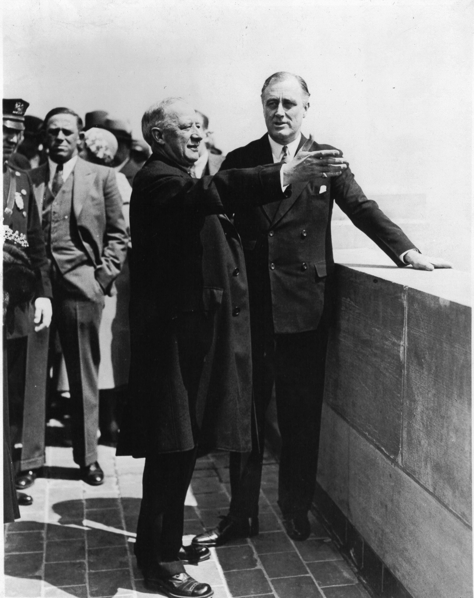 Former Governor Alfred E. Smith points out the sights of the city to Governor Roosevelt from an Empire State Building observation floor on May 1, 1931.