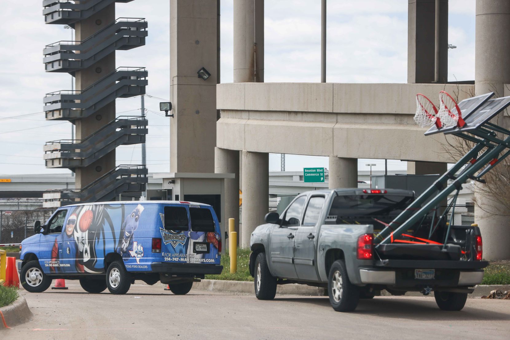 A van with the NBA team Mavericks logo, arrives along with a pickup carrying two basketball hoops to the Kay Bailey Hutchison Convention Center in Dallas on Thursday, March 18, 2021, where 200 unaccompanied immigrant children arrived Wednesday evening. The convention center serves as an emergency intake site to hold teens who have apprehended in increasing numbers at the U.S.-Mexico border.