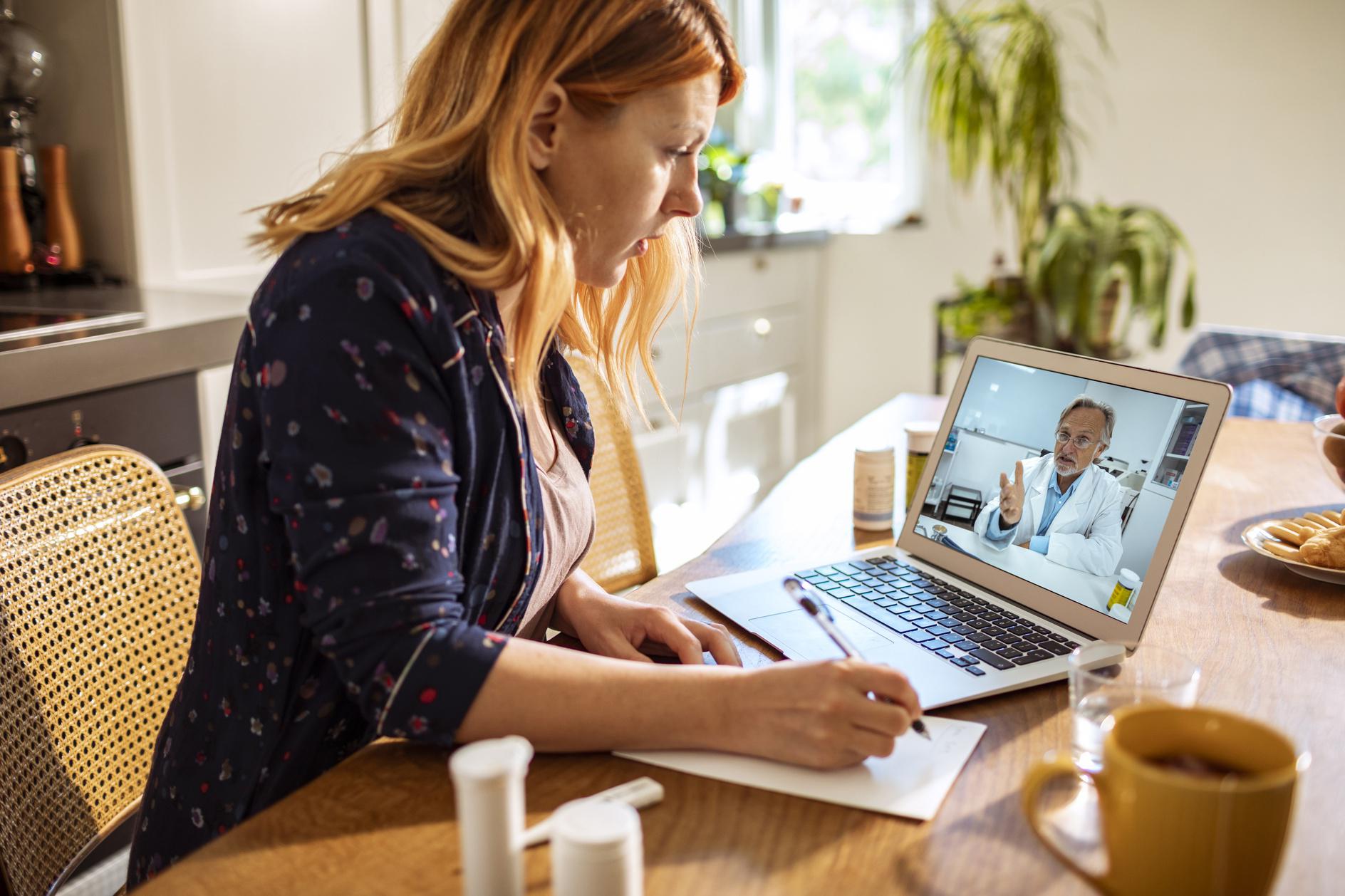 Young woman consulting with her doctor over a video call