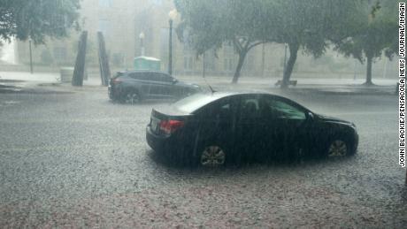 Heavy rain falls in downtown Pensacola, Florida, on Saturday.