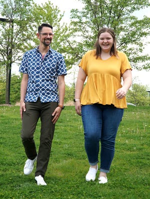 South Lyon East High student Josie Cadicamo walks with her teacher Jeff Steger on campus on May 17, 2021.