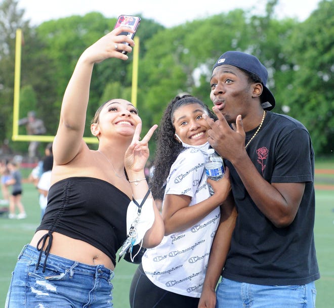 From left, Jolisa Pettiford, Nessa Ferman and Kamani Lee take a selfie at Brockton High School's Class of 2021 senior field day at Marciano Stadium on Thursday, May 27, 2021.